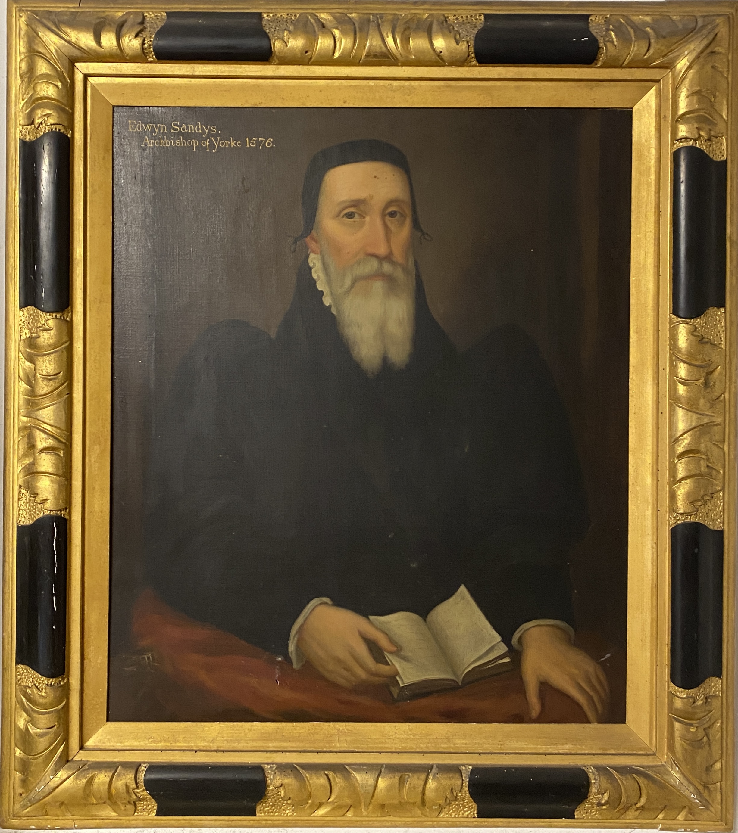 An image of a man with a beard on the left and a school seal showing a school master and a student on the right 